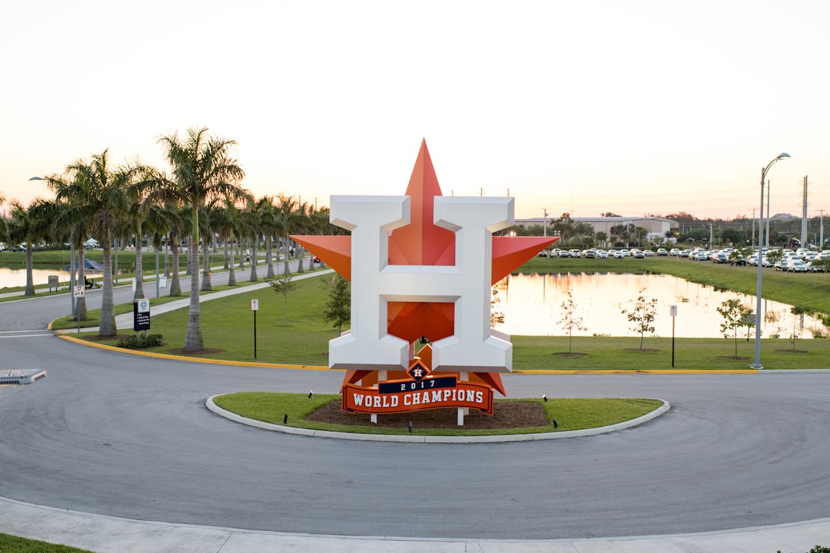 a red and white fire hydrant on the side of a road